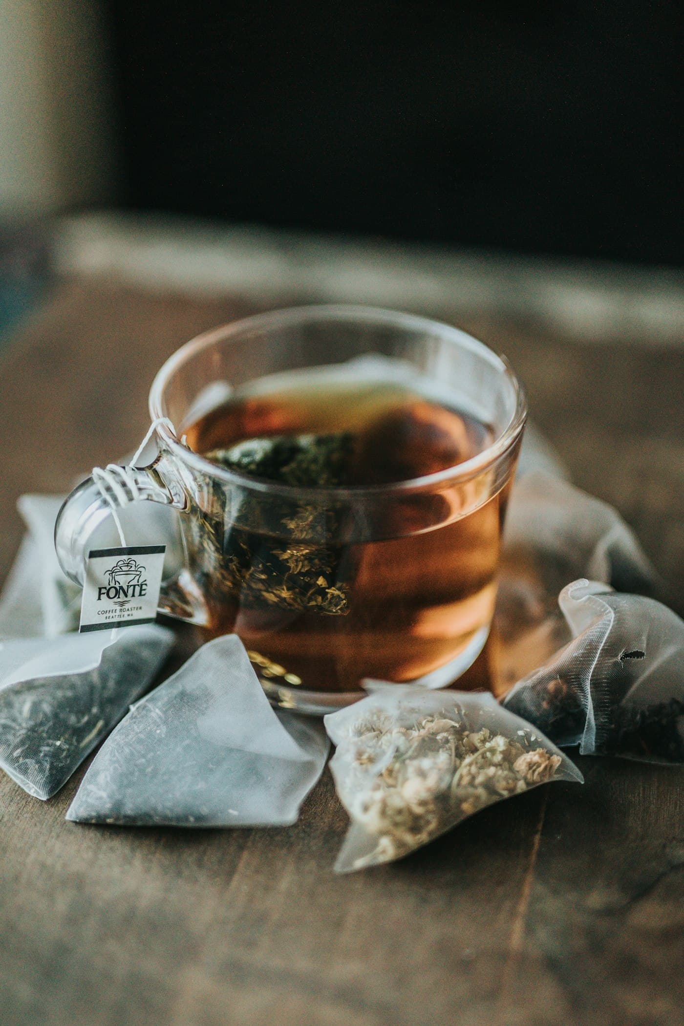 Loose-leaf tea steeping in a glass cup
